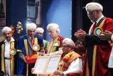A man receiving an honorary degree during a convocation ceremony at KSOU.